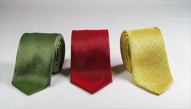 Symbol photo, traffic light, three ties, one each in red, green and yellow, on a white surface, AI
