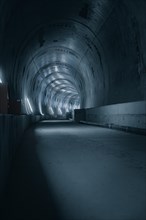 Long, gloomy tunnel with sporadic lighting, tunnel construction Hermann Hessebahn, Ostelsheim,