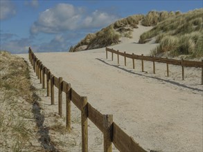 Sand dunes by the sea with blue sky and clouds, nes, ameland, netherlands