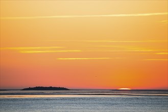 Picturesque, golden, breathtakingly beautiful sunset over the sea, last moments in front of the sun