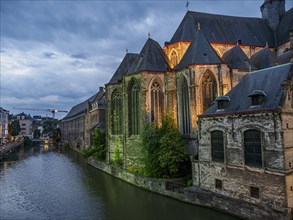 Blue hour with historic houses by the river with old lanterns, Ghent, Belgium, Europe
