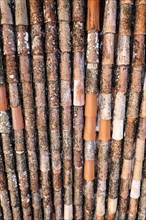 Close-up of several worn and rusty pipes in brown and orange tones