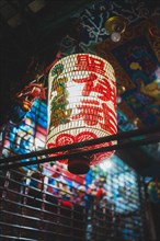 Traditional Chinese painted lamp illuminates the streets of China Town in Bangkok, Thailand at