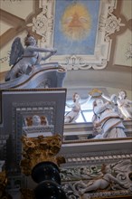 Statue and the Eye with Triangle Painted on the Ceiling with Window Light Inside the Church of San