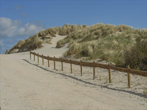Sand dunes by the sea with blue sky, nes, ameland, netherlands