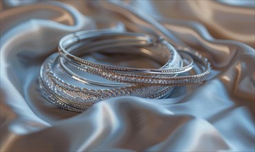 Set of silver bracelets arranged on a satin material background AI generated