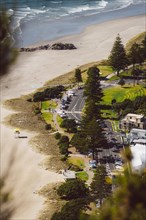 View from the viewpoint of Mount Manganui with a view of a road on the beach with the sea in the