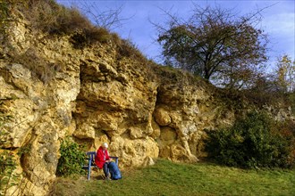 Hiker at the Burschel geotope, Riesse limestones, Hainsfarth, Ries crater rim, Noerdlinger Ries,