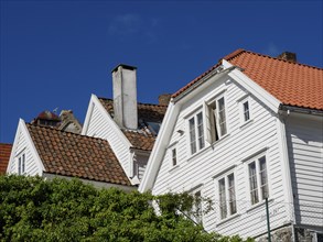 White houses with red tiled roofs, bright blue sky, windows with shutters, historical atmosphere,