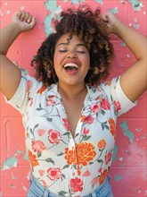 Joyful plus size woman with curly hair laughing heartily in front of a pink wall, AI generated