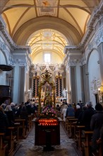 People Praying Inside the Church of San Nazzaro (Croglio) in Castelrotto, Ticino, Switzerland,