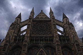 Gothic side portal (detail) of Westminster Abbey in rainy weather, Dean's Yard, London, England,