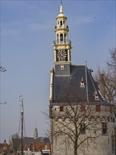 Historic clock tower with a view of the city and sailing boats against a blue sky, tower with a