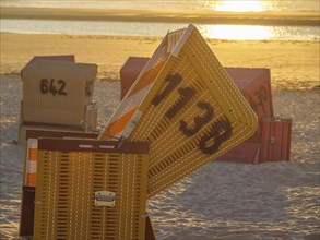 Close-up of a yellow beach chair with the sea in the background, sunset, sunset on a quiet beach