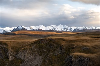 Glaciated and snow-capped mountains, dramatic mountain landscape, autumnal plateau with yellow