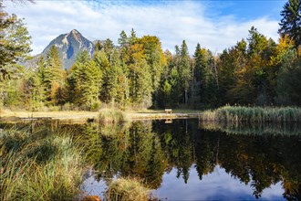 Idyllic view of a lake with reflection surrounded by autumn forest and mountains, Kernwald, Kerns,