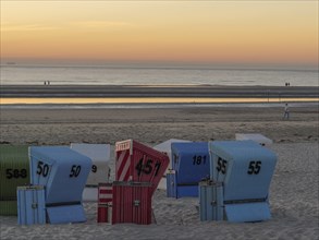 Sunset on the beach with colourful beach chairs and calm atmosphere, beautiful sunset on the beach