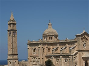 Neo-Romanesque basilica with impressive dome and high bell tower under a blue sky, stand-alone