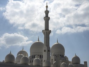 The mosque with its domes and minarets stretches majestically into the cloudy sky, large mosque
