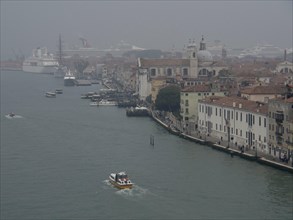 View of Venice, recognisable by the many boats and historic buildings along the canal, church