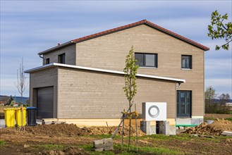 New build modern detached house with timber facade and heat pump, energy-saving house, efficiency