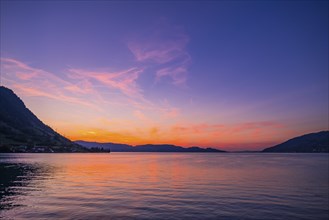 Sunset with vivid colours over Lake Zug, surrounded by mountains, Arth, Switzerland, Europe