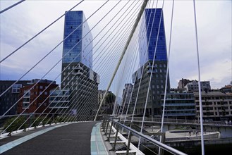 Pedestrian bridge Zubizuri, White Bridge, Bilbao, Pedestrian bridge with modern skyscrapers in the