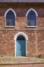 Arched windows and door to St Laurentius Church in Toenning, North Friesland district,