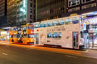 Hong Kong Tramways double-decker trams public transport at the Pedder Street stop in Hong Kong,