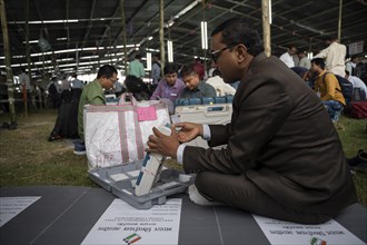 Barpeta, India. 6 May 2024. Polling officials check Electronic Voting Machines (EVMs) before