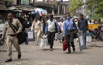 Barpeta, India. 6 May 2024. Polling officials carries Electronic Voting Machines (EVMs) and Voter