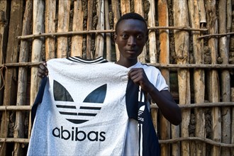 Teenage boy showing a counterfeit sports garment, adidas, ethiopia