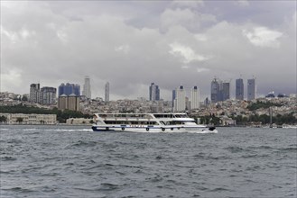 Ship sailing on the water with a view of Istanbul's modern city skyline, Istanbul, Istanbul
