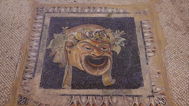 A colourful antique mosaic of a theatre mask surrounded by patterns, interior view, Grand Master's