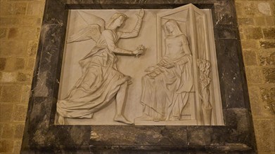 Stone relief of an angel addressing Mary, in a historical style, interior, Grand Master's Palace,