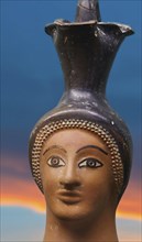 Oinochoe, ancient Greek wine jug with handle in the shape of a woman's head, motif cropped and