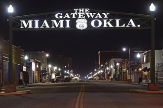 Night shot of illuminated main road with neon lettering above the road, Route 66, Miami, Oklahoma