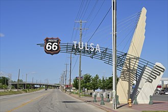 Route 66 road sign hangs large above the road, Tulsa, Oklahoma
