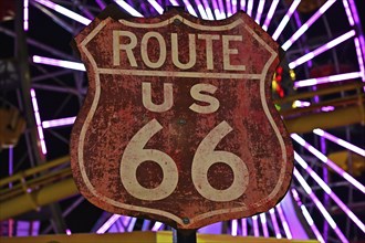 Route 66 sign in front of the Ferris wheel on the pier in Santa Monica, California