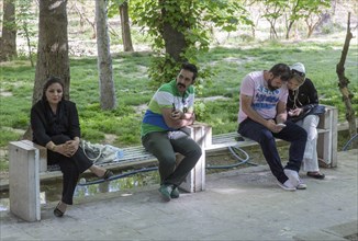 A young Iranian couple an Iranian woman and an Iranian man on 03/04/2015 sitting on a bench in the