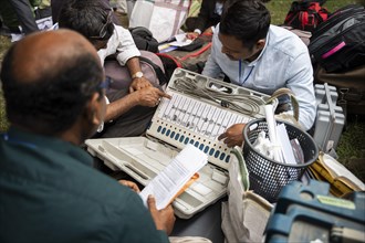Barpeta, India. 6 May 2024. Polling officials check Electronic Voting Machines (EVMs) before