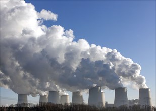 Steam rises from the cooling towers of the Vattenfall power plant in Jaenschwalde, power lines and