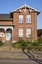 Brick building with front garden in Schafstedt, Dithmarschen district, Schleswig-Holstein, Germany,