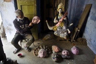 Craftsman making masks, masks used for the Seraikela Chhau dance, Jharkhand, India. Representation