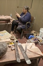 Pipestone, Minnesota, A Native American uses files in making pipes from pipestone at Pipestone