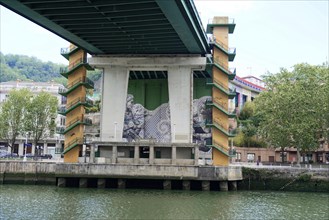 La Salve Bridge, A bridge with artistic graffiti on concreted pillars over a river Nervion, in the