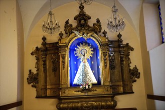 Iglesia San Nicolas de Bari, altar with Madonna against a blue background and golden decorations,