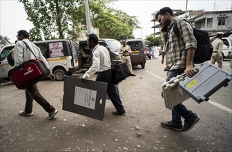 Barpeta, India. 6 May 2024. Polling officials carries Electronic Voting Machines (EVMs) and Voter