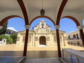 View through archway to main entrance portal of orthodox church monastery church Zoodochos Pege in