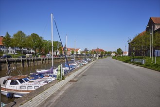 Road along the quay in the harbour of Toenning, district of Nordfriesland, Schleswig-Holstein,